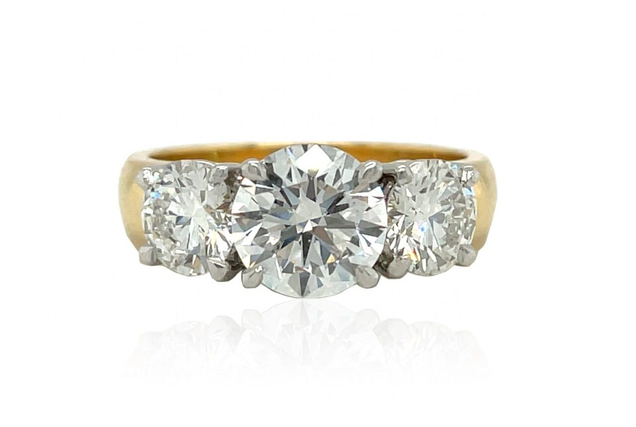 Three across diamond ring set in platinum, white gold, yellow gold
