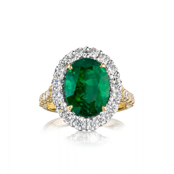 8 karat yellow gold and platinum claw and shared claw set cluster style emerald and diamond ring.