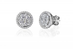18 karat white gold claw and grain set halo style diamond earrings.