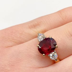 Oval cut 3 across Ruby and white diamond ring