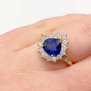 Pear cut sapphire with diamond cluster ring