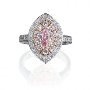 A marquise pink diamond ring in 18 karat white gold, with a halo of pink diamonds, grainset with round brilliant cut diamonds.