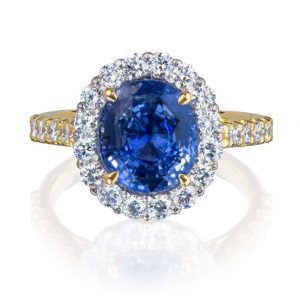 natural unheated sapphire and diamond cluster ring in platinum and 18 karat yellow gold, with diamond set shoulders