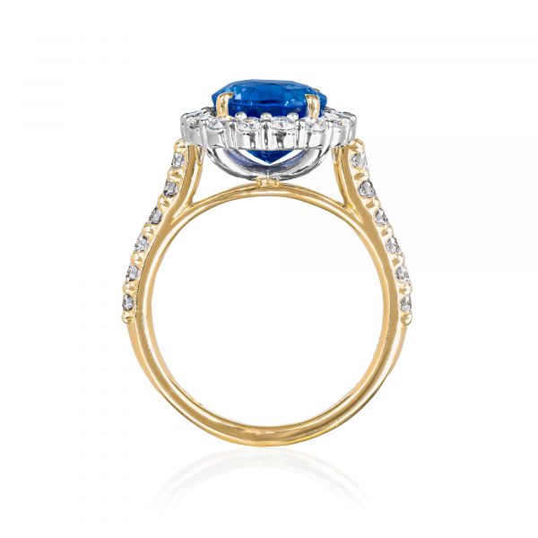 natural unheated sapphire and diamond cluster ring in platinum and 18 karat yellow gold, with diamond set shoulders standing