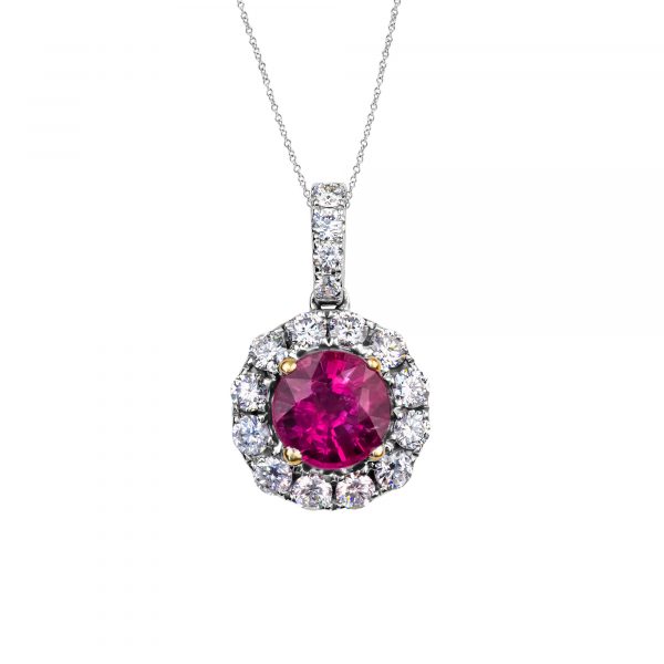 ruby and diamond pendant in 14 karat white gold with claws in 18 karat yellow gold, featuring a round ruby weighing 1.64ct within a surround of round brilliant cut diamonds
