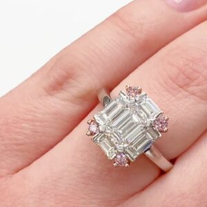 Ring with emerald cut diamonds and four pink round cut diamonds